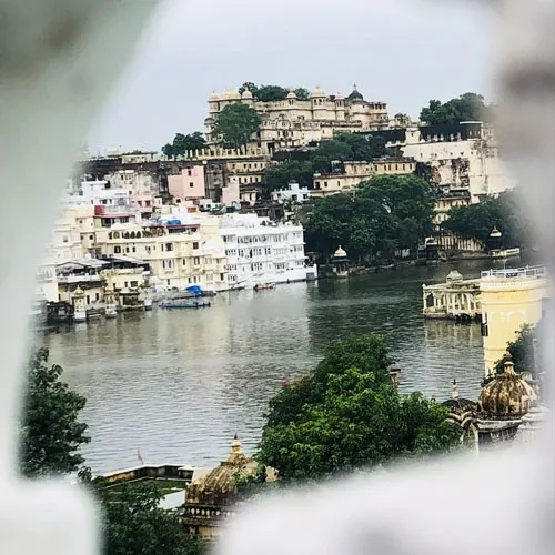 Boat on Lake Pichola with Udaipur City Palace behind